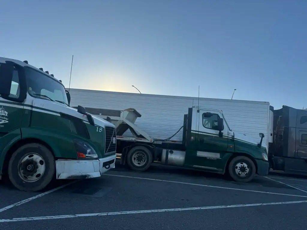 Semi-trucks parked at dusk after mobile CARB compliance testing