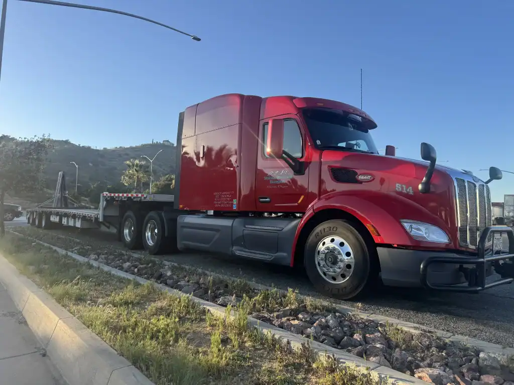 Red semi-truck with flatbed trailer tested roadside by All Smog Motors