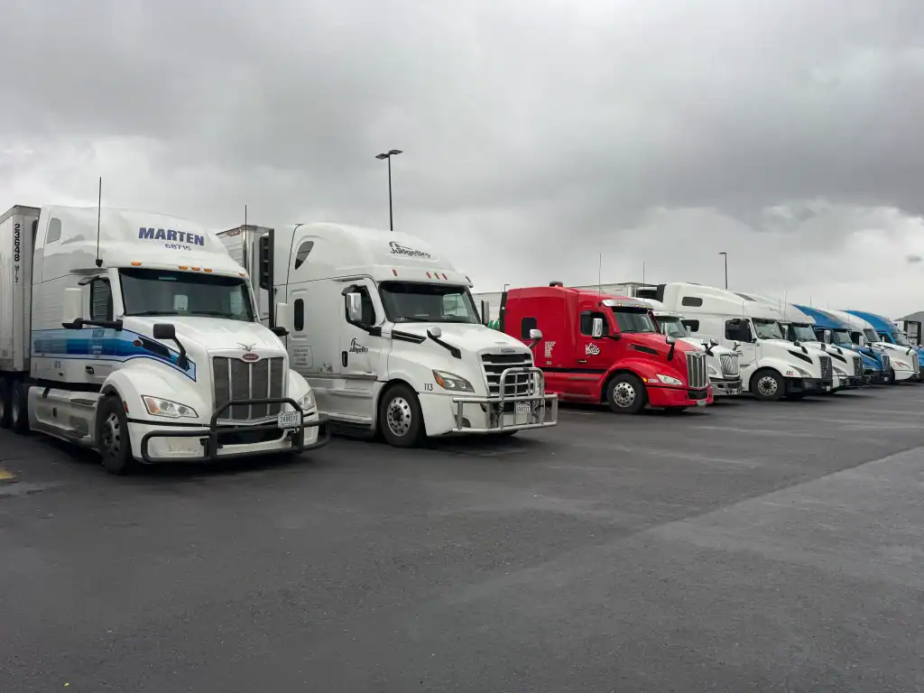Row of semi-trucks parked at a Los Angeles County fleet yard before Clean Truck Check testing